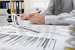 Business concept - businessman working with reports in office, table and workspace close view, analyzing financial data, writes