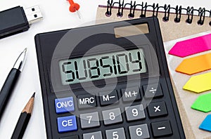 Business concept. calculator, and financial documents in the center inscription -SUBSIDY