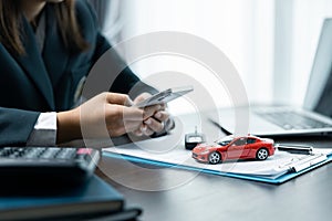 Business concept, car insurance, sell and buy car, car financing, car key for vehicle sales agreement. A car dealer is explaining