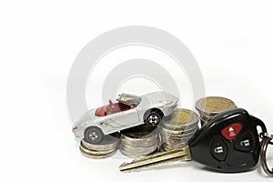 Business concept of car loan, gray car and stacks of coins