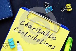 Business concept about Charitable Contributions with sign on the page