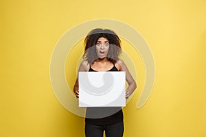 Business Concept - Close up Portrait young beautiful attractive African American shocking expression showing plain white