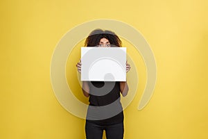 Business Concept - Close up Portrait young beautiful attractive African American smiling showing plain white blank sign