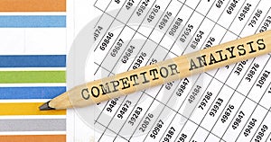 Business concept COMPETITOR ANALYSIS text on the pencil on chart background