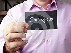 Business concept about Contagious  with sign on the page