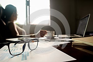 Business concept with copy space. Office desk table with pen focus and analysis chart, computer, notebook, cup of coffee on desk.