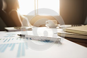 Business concept with copy space. Office desk table with pen focus and analysis chart, computer, notebook, cup of coffee on desk.