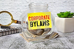 Business concept. Corporate Bylaws lettering on the money jar photo