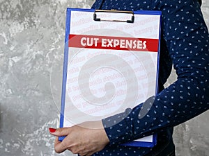 Business concept about CUT EXPENSES with sign on the piece of paper