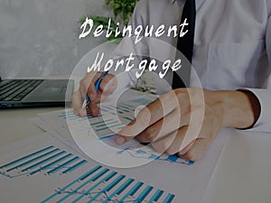 Business concept about Delinquent Mortgage with inscription on the sheet