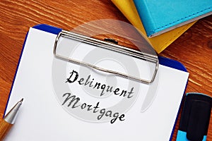 Business concept about Delinquent Mortgage with sign on the page