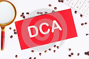Business concept. Dollar cost averaging investment strategy. DCA on a red card