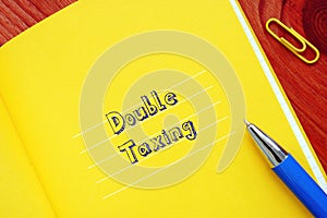 Business concept about Double Taxing with inscription on the sheet photo