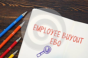 Business concept about Employee Buyout EBO with sign on the piece of paper