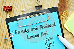 Business concept about FMLA Family And Medical Leave Act with sign on the page