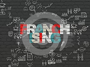 Business concept: Franchising on wall background