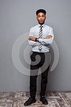 Business Concept - Full length portrait of confident african american businessman in the office.