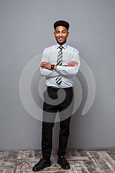 Business Concept - Full length portrait of confident african american businessman in the office.