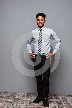 Business Concept - Full length portrait of confident african american businessman in the office.