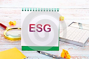 Business concept. Future environmental conservation and sustainable ESG modernization. Words ESG on a white notebook