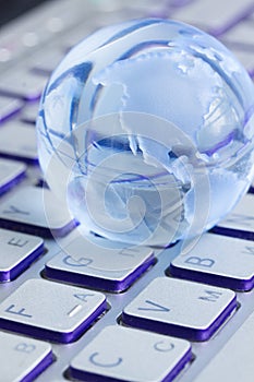 Business concept with globe on laptop keyboard