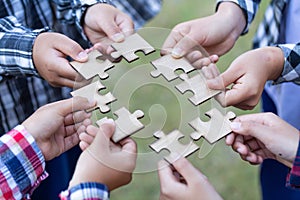 Business concept,  Group of business people assembling jigsaw puzzle and represent team support and help togethe