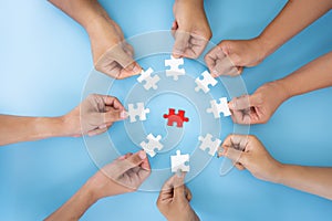 Business concept,  Group of business people assembling jigsaw puzzle and represent team support and help togethe