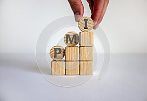 Business concept growth success process. Male hand. Wood blocks and circles with word `PMI, purchasing manager index` stacking a