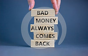 Business concept growth success process. Wood blocks on grey background, copy space. Businessman hand. Words `bad money always