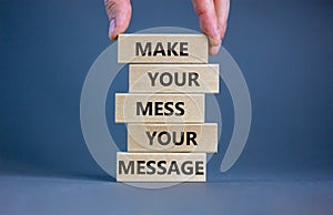 Business concept growth success process. Wood blocks on grey background, copy space. Businessman hand. Words `make your mess your