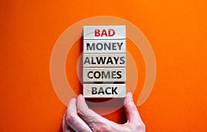 Business concept growth success process. Wood blocks on orange background, copy space. Businessman hand. Words `bad money always