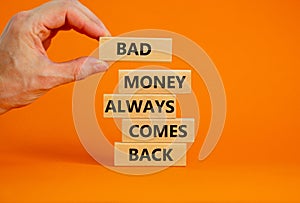 Business concept growth success process. Wood blocks on orange background, copy space. Businessman hand. Words `bad money always