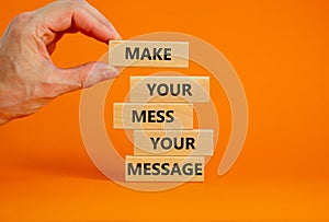 Business concept growth success process. Wood blocks on orange background, copy space. Businessman hand. Words `make your mess