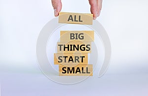 Business concept growth success process. Wood blocks on white background, copy space. Businessman hand. Words `all big things