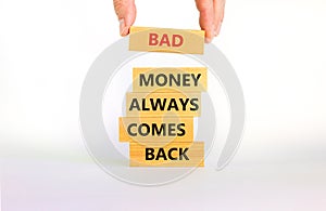 Business concept growth success process. Wood blocks on white background, copy space. Businessman hand. Words `bad money always