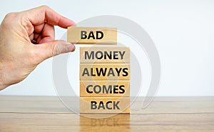 Business concept growth success process. Wood blocks on white background, copy space. Businessman hand. Words `bad money always