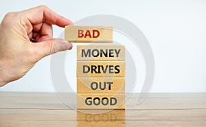 Business concept growth success process. Wood blocks on white background, copy space. Businessman hand. Words `bad money drives