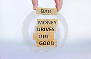 Business concept growth success process. Wood blocks on white background, copy space. Businessman hand. Words `bad money drives