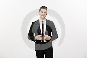 Business Concept: Handsome Man Happy Smile Young Handsome Guy in smart suit posing over Grey Background.