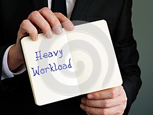 Business concept about Heavy Workload with sign on the sheet