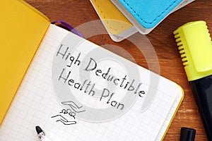 Business concept about high deductible health plan with sign on the piece of paper