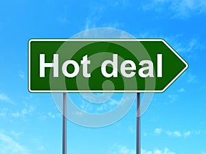 Business concept: Hot Deal on road sign background
