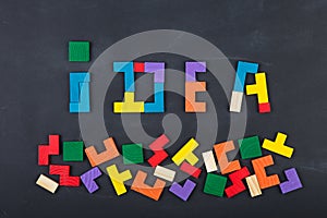 Business concept - Idea composed of color jigsaw blocks on the blackboard