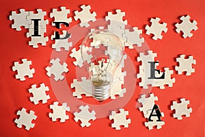 Business concept,idea,solution,innovation, team building,teamwork.Light bulb and jigsaw puzzle with caption. Free copy space