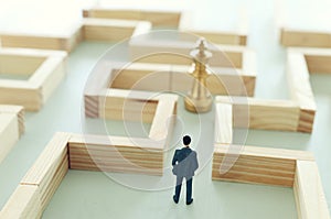 Business concept image of and challenge. A man stands in the maze looking for the exit. Problem solving and decision making idea