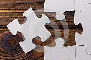 Business concept image for completing the final puzzle piece. wooden background.