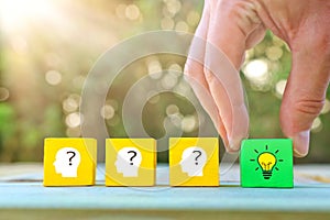 Business Concept image of revealing an idea, finding the right solution during creative process. Hand picking cube with bright