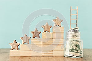 Business concept image of setting a five star goal. increase rating or ranking, evaluation, money investment and financial growth photo