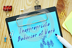 Business concept about Inappropriate Behavior at Work with sign on the page