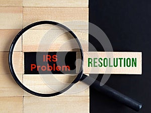 Business Concept - IRS Problem Resolution with magnifying glass background. Stock photo.